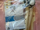 a package of toothbrushes in a plastic bag on a pink surface