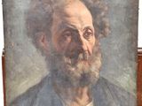 an old painting of a man with a beard on a wooden easel