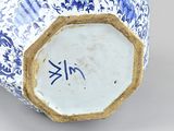a blue and white vase sitting on a table
