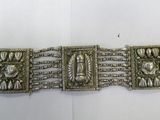 an image of a silver bracelet on a white surface
