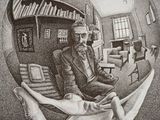 reflection of a man sitting in a chair in a glass ball