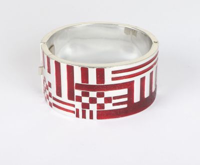 silver ring with red and white squares on it