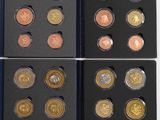 a group of six different colored coins in a black box