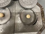 a silver tray with two silver dishes on top of it