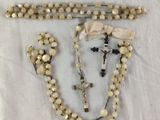 rosary and crucifix on a white cloth on a table