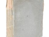 an old book that is sitting on a white surface