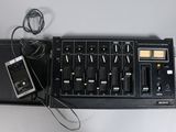 a remote control and a mixer on a table