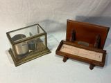 two different types of clocks on display on a table