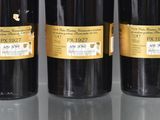 three bottles of wine sitting on top of a table next to each other