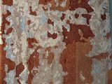 a close up of a piece of fabric with peeling paint on it