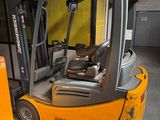 a fork lift truck that is parked in a warehouse