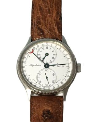 a close up of a watch on a white background