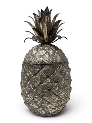 a close up of a metal pineapple on a white background