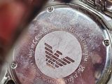 a close up of a wrist watch with a logo on it