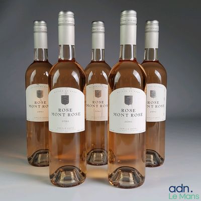 four bottles of wine are lined up in a row on a table