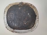 a picture of a piece of metal hanging on a wall