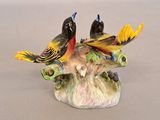 two birds that are sitting on top of a tree branch