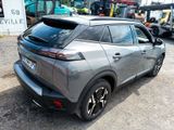 the rear end of a gray car parked in a lot