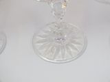 many wine glasses sitting on a table with a white table cloth