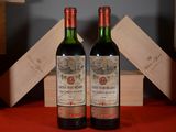 two bottles of wine sitting next to each other on a table
