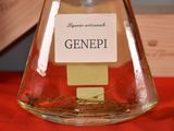 a glass flask with a label on it sitting on a table
