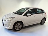 a white citrole is parked in a white room