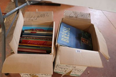 two boxes of books sitting on the floor next to each other