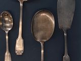 several spoons and spoon spoons are lined up on a table