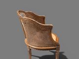 an image of a wicker chair with a shadow on the floor