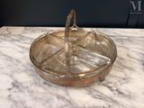 a glass tray with a handle on a marble table