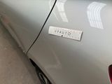 a sticker on the side of a silver car