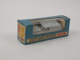 a small toy car in a box on a white surface