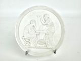 a white plate with a picture of a man and a woman sitting at a table