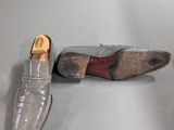 pair of men ' s shoes on display in a museum display case