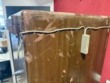 a wooden refrigerator with a metal latch on it