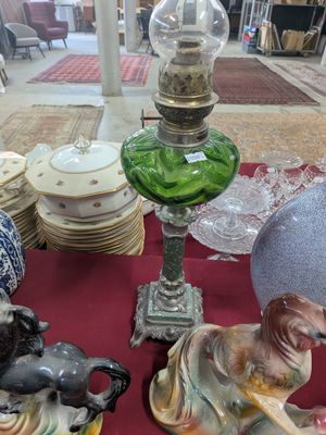 a table with a bunch of figurines and vases on it