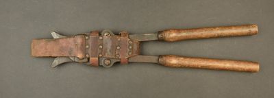 an old pair of pliers with leather handles on a table