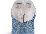 a ceramic sculpture of a man ' s face with a beard