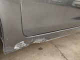 a car that has been dented and is parked in a garage