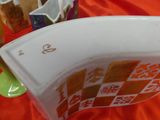 a white bowl with orange and yellow designs on it