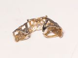 two gold and silver rings with black diamonds on a white surface