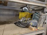 a pile of tools sitting on a shelf in a garage
