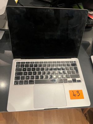 a laptop computer sitting on top of a desk next to a cell phone