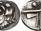 a close up of a coin with a cross on it