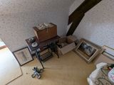 an image of a living room with a lot of stuff on the floor