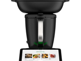 a black blender sitting on top of a tablet computer