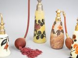 five different types of perfume bottles with tassels on them