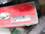 a close up of a red box with a button on it
