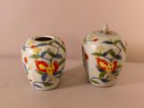 two vases that are sitting on a table