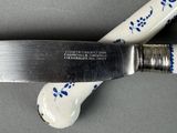 a knife that is laying on top of a knife holder